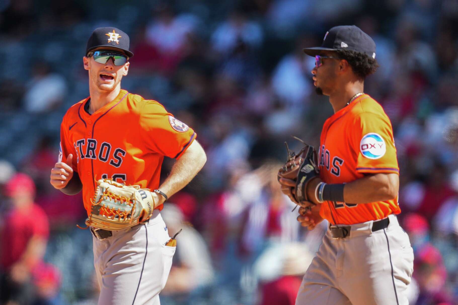 Houston Astros left fielder Zach Cole, left, talks with second baseman Brice Matthews as they jog from the dugout during an MLB baseball game in Anaheim, Sunday, Sept. 28, 2025.