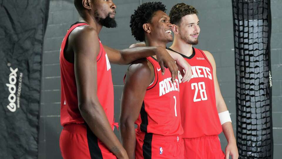 Houston Rockets including Kevin Durant (from left) Amen Thompson and Alperen Sengun pose for a photo during media day at the Toyota Center in Houston on Monday, Sept. 29, 2025.