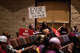 UVALDE, TX - AUGUST 24: Attendees hold signs as the Uvalde Consolidated Independent School District Board holds a special meeting to consider the firing of Police Chief Pete Arredondo on August 24, 2022 in Uvalde, Texas. Arredondo was fired over the police response to the May 24 massacre at Robb Elementary School, Americaâs deadliest school shooting since 2012. (Photo by Jordan Vonderhaar/Getty Images)