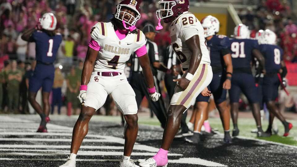 Summer Creek wide receiver Benny Easter Jr., left, celebrates with running back Braylin Causey after his 1-yard touchdown run gave the Bulldogs a 37-35 lead with six seconds remaining in the second half of a District 23-6A high school football game in Humble, Friday, Oct. 3, 2025.