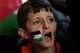 A young demonstrator with a Palestinian flag painted on his face