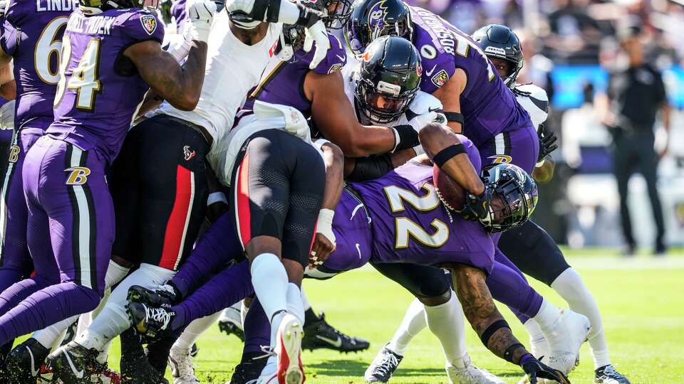 Baltimore Ravens running back Derrick Henry (22) is stopped at the line of scrimmage by the Houston Texans defense during the first half of an NFL football game at M&T Bank Stadium in Baltimore, Sunday, Oct. 5, 2025.
