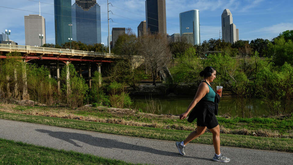 People enjoy a warm day at Buffalo Bayou Park on Monday, Feb. 26, 2024, in Houston .