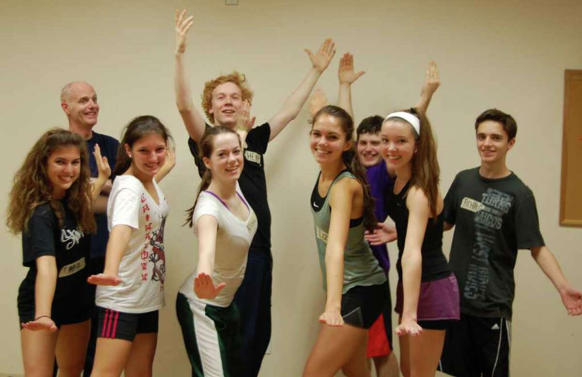 From left, Carol DeSalva of Redding, Tailor Dortona of Greenwich, Henry Ayrs-Brown of New Haven, Allison Griffith of Redding, Liz Stillman of Greenwich, Daniel Klingenstein of New Canaan, Nicole Bloom of Darien and Richard Westfahl of Stamford, practice some moves with choreographer Larry Nye, at left in background, at rehearsal Tuesday in Manhattan for the Macy's Thanksgiving Day Parade. Photo by Lisa Chamoff/staff writer