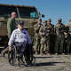 National Guard members stand behind Texas Gov. Greg Abbott and fellow governors as they hold a press conference along the Rio Grande at the U.S.-Mexico border to discuss Operation Lone Star and border concerns on Sunday, February 4, 2024 in Eagle Pass, TX.