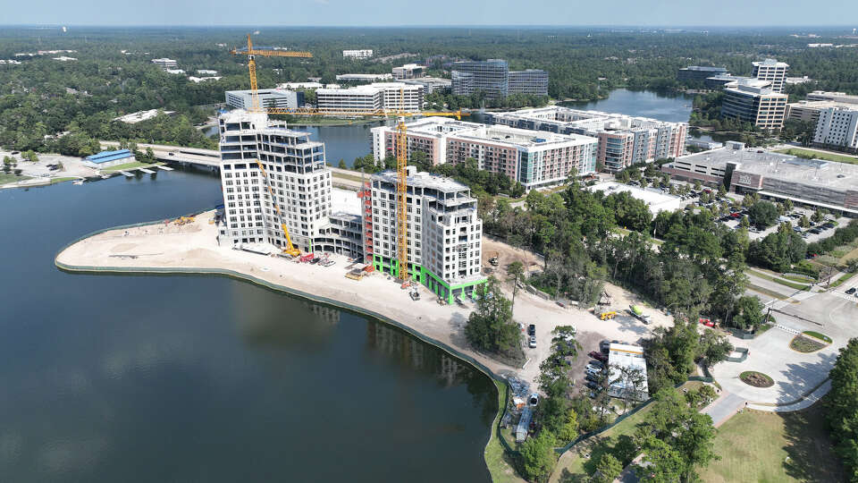 An Oct. 2, 2025 aerial image showing the Ritz-Carlton Residences, The Woodlands, an 111-unit luxury condo tower under construction near Lake Woodlands north of Houston.
