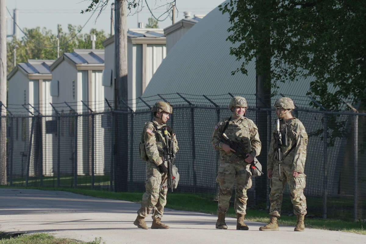 Military personnel in uniform, with the Texas National Guard patch on, are seen at the U.S. Army Reserve Center, Wednesday, Oct. 8, 2025, in Elwood, Ill., a suburb of Chicago. (AP Photo/Laura Bargfeld)