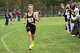 Amity's Luke Cushing nears the finish line in first place in the 5,000 meters during the SCC high school cross country championships at East Shore Park in New Haven, Conn., Wednesday, October 15, 2025.