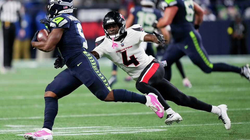 Seattle Seahawks running back Kenneth Walker III (9) runs against Houston Texans cornerback Kamari Lassiter (4) during the first half of an NFL football game, Monday, Oct. 20, 2025, in Seattle.
