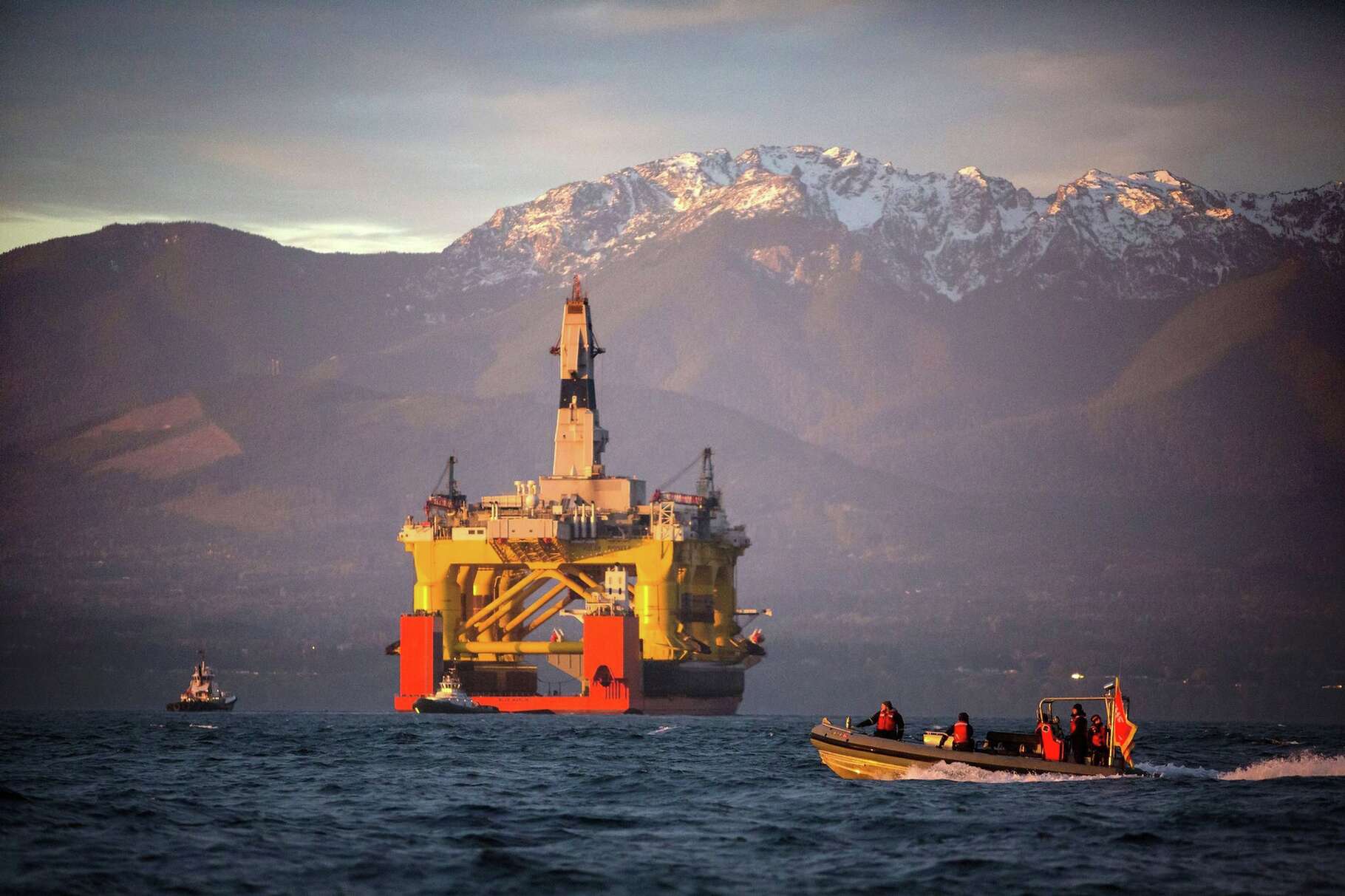 In this April 17, 2015 file photo, a small boat crosses in front of the Transocean Polar Pioneer, a semi-submersible drilling unit that Royal Dutch Shell leases from Transocean Ltd., as it arrives in Port Angeles, Wash. aboard a transport ship after traveling across the Pacific before its eventual Arctic destination. The Interior Department announced Friday, Oct. 16, it is canceling future lease sales and will not extended current leases in Arctic waters off Alaska's northern coast, a decision that significantly reduces the chances for future Arctic offshore drilling. (Daniella Beccaria/seattlepi.com via AP, File) MAGS OUT; NO SALES; SEATTLE TIMES OUT; TV OUT; MANDATORY CREDIT