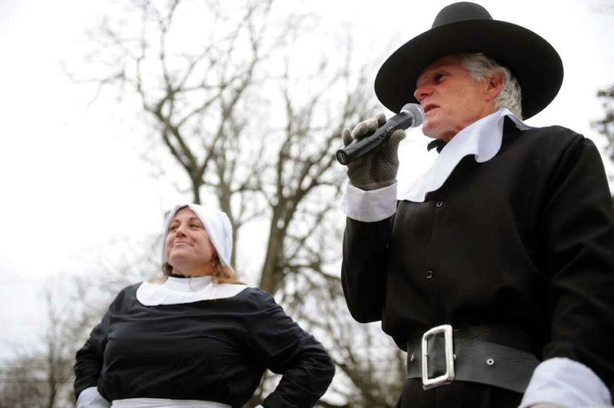 Ray Rodgers, right, speaks as a pilgrim before the start of the 33rd Pequot Running Club Thanksgiving Day five-mile race in Southport on November 25, 2010.