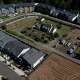 FILE - New construction homes and apartments are seen surrounding an older home on Friday, July 11, 2025, in Happy Valley, Ore.