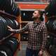 Man looking at rows and rows of tires in a tire store.