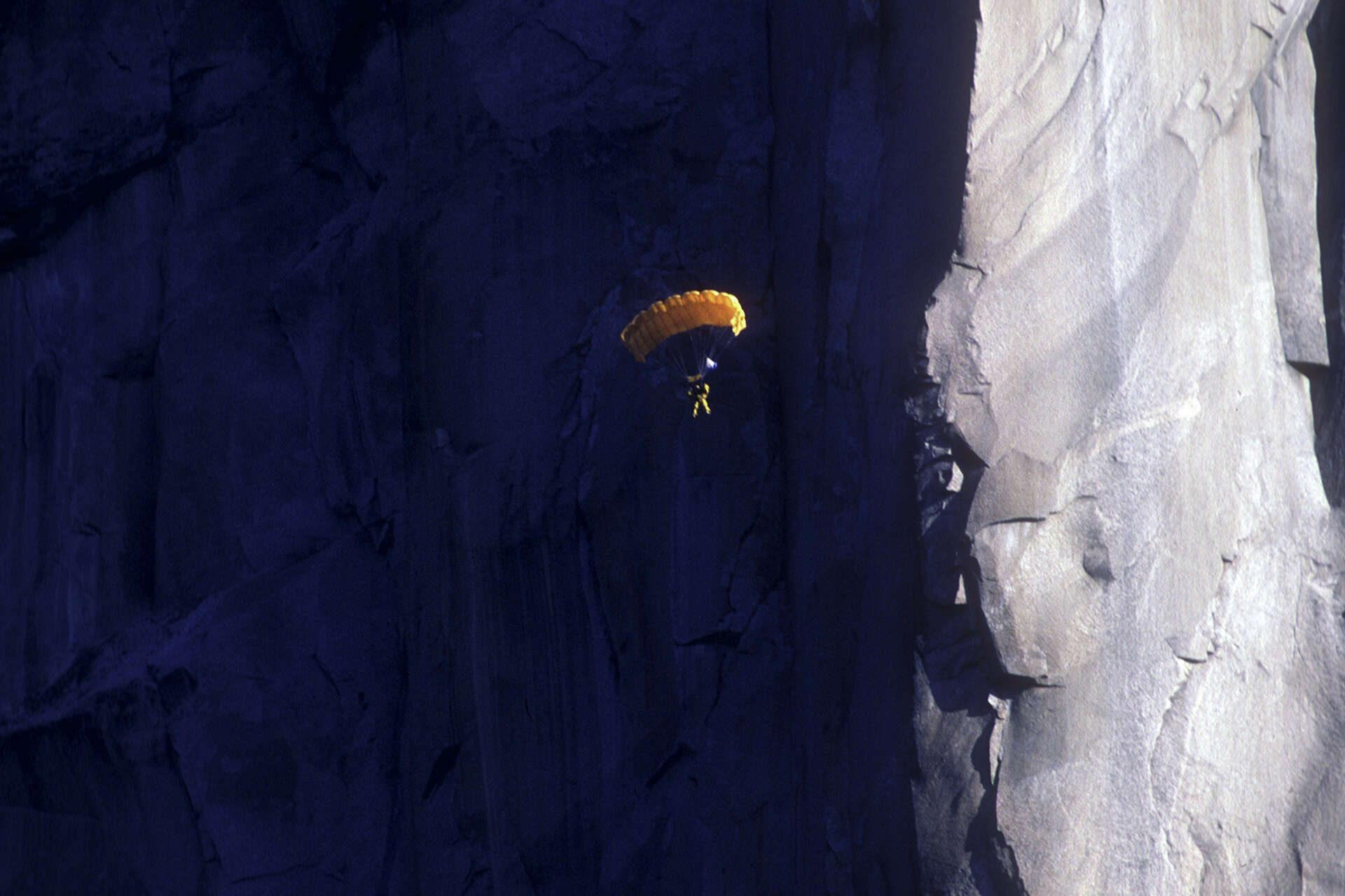 BASE jumper parachuting off El Capitan cliff in Yosemite National Park