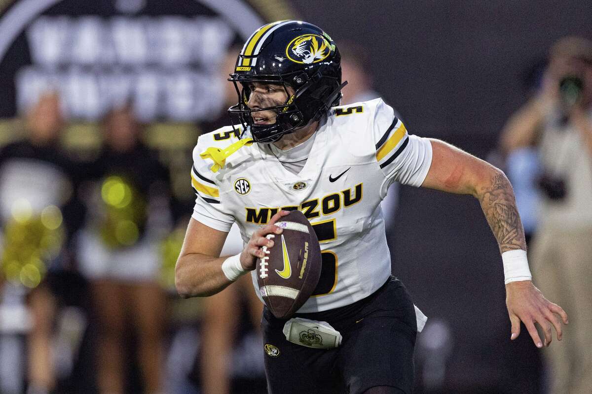 Missouri quarterback Matt Zollers rolls out to pass during the second half of an NCAA college football game against Vanderbilt, Saturday, Oct. 25, 2025, in Nashville, Tenn.