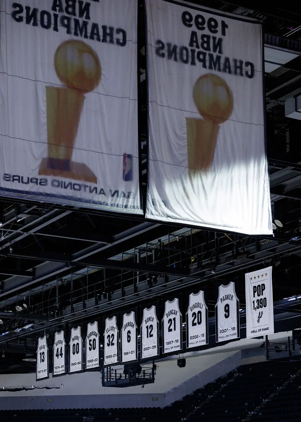 A new banner honoring former San Antonio Spurs head coach Gregg Popovich is unveiled before the Spurs’ home opener against the Brooklyn Nets at Frost Bank Center in San Antonio on Sunday afternoon, Oct. 26, 2025. The banner reads “Pop 1,390,” which represents Popovich’s NBA-record regular-season win total with the team.