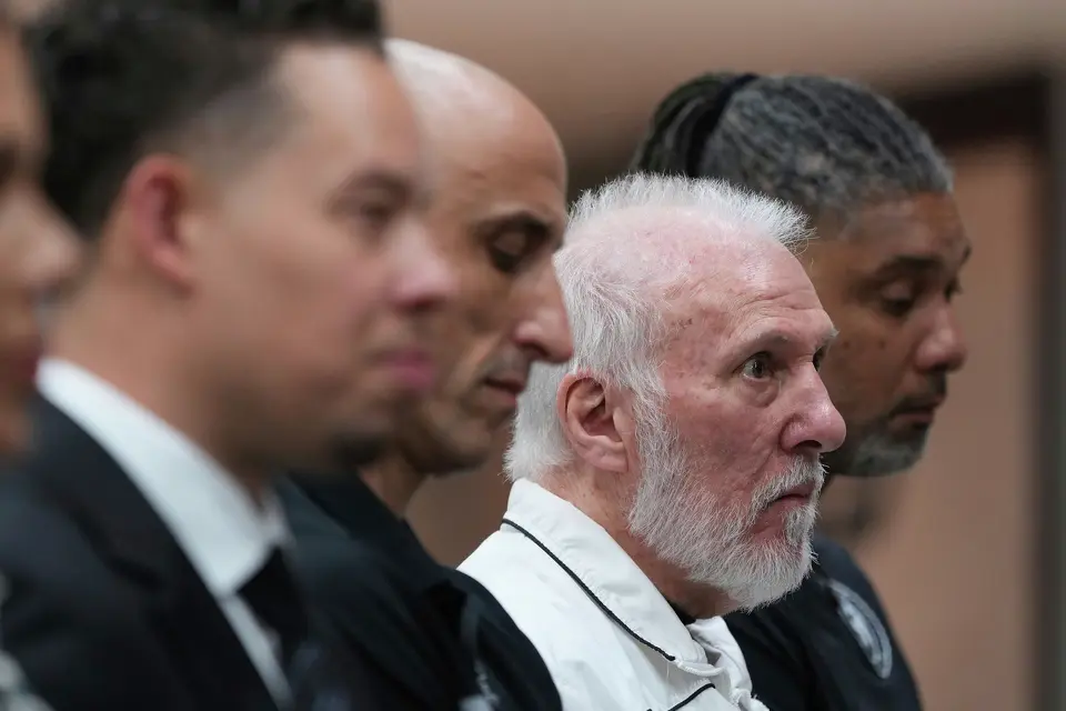 FILE - Former San Antonio Spurs head coach Gregg Popovich, second from right, sits between former players Manu Ginobili and Tim Duncan, right, as he waits to introduce Mitch Johnson, left, as the new head coach of the San Antonio Spurs NBA basketball team, in San Antonio, Monday, May 5, 2025.