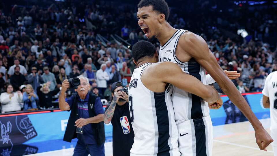 San Antonio Spurs forward Keldon Johnson (3) embraces San Antonio Spurs forward Victor Wembanyama (1) as they celebrate their victory over the Miami Heat at Frost Bank Center in San Antonio, Thursday, Oct. 30, 2025. The Spurs defeated the Heat, 107-101, to secure their first 5-0 start in franchise history.