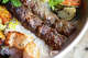 A platter of kabobs and grilled vegetables from Panini Kabob Grill in Los Angeles on Oct. 30, 2025.