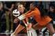 Texas Longhorns libero Emma Halter (2) and outside hitter Torrey Stafford (4) attempt to return a serve during the game against Texas A&M at Reed Arena on Friday, Oct. 31, 2025 in College Station, Texas.