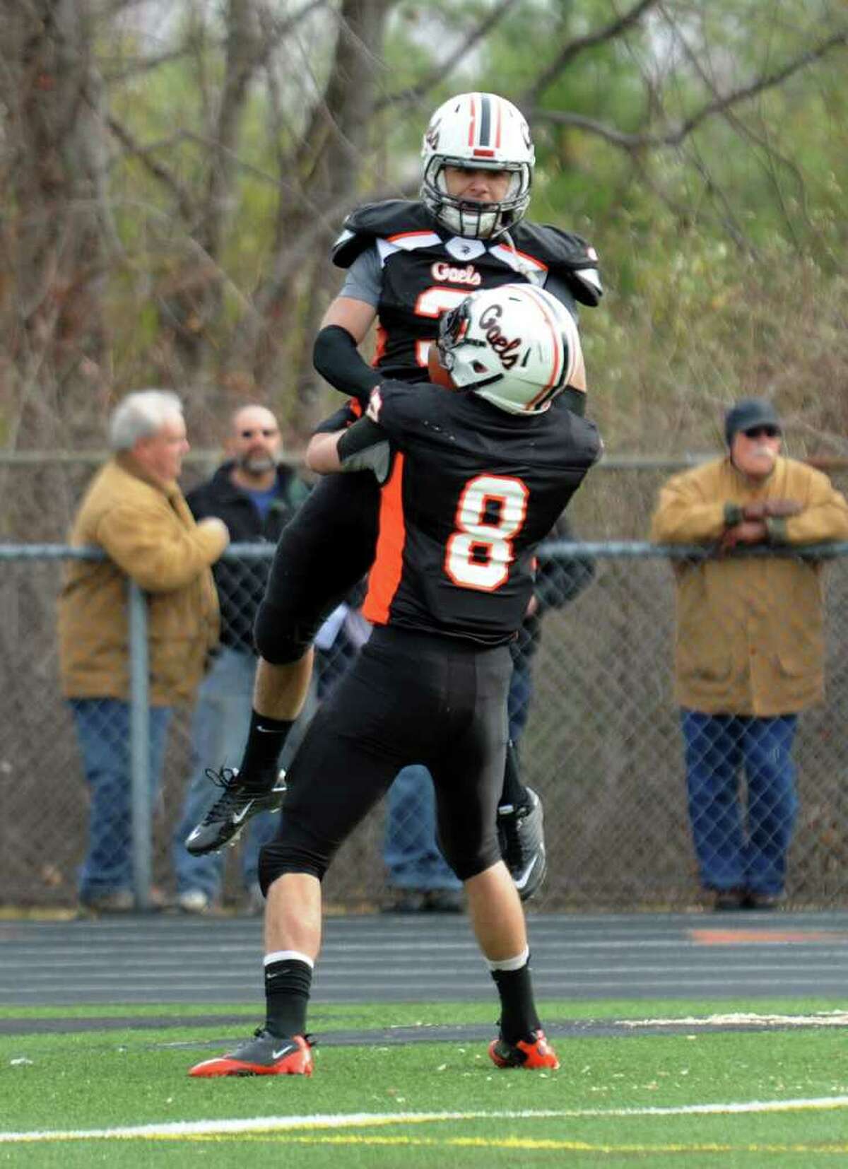 Shelton's #3 Ed Ostrowski leaps into the arms of teammate #8 Michael Georgalas after a touchdown by Ostrowski, during Thanksgiving Day Classic football action between Shelton and Derby in Shelton, Conn. on Thursday November 24, 2010.