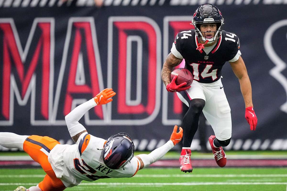 Houston Texans wide receiver Jaylin Noel (14) leaps over Denver Broncos safety Devon Key (26) as he returns a punt during the second half of an NFL football game at NRG Stadium in Houston, Sunday, Nov. 2, 2025.