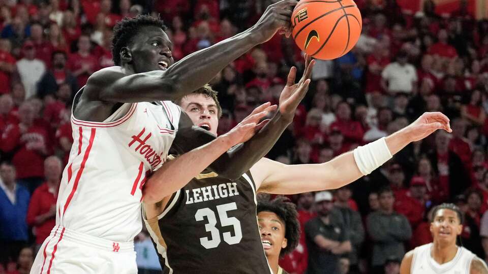 Houston forward Kalifa Sakho (14) and Lehigh forward Hank Alvey (35) fight for a rebound during the first half of an NCAA college basketball game at Fertitta Center in Houston, Monday, Nov. 3, 2025.