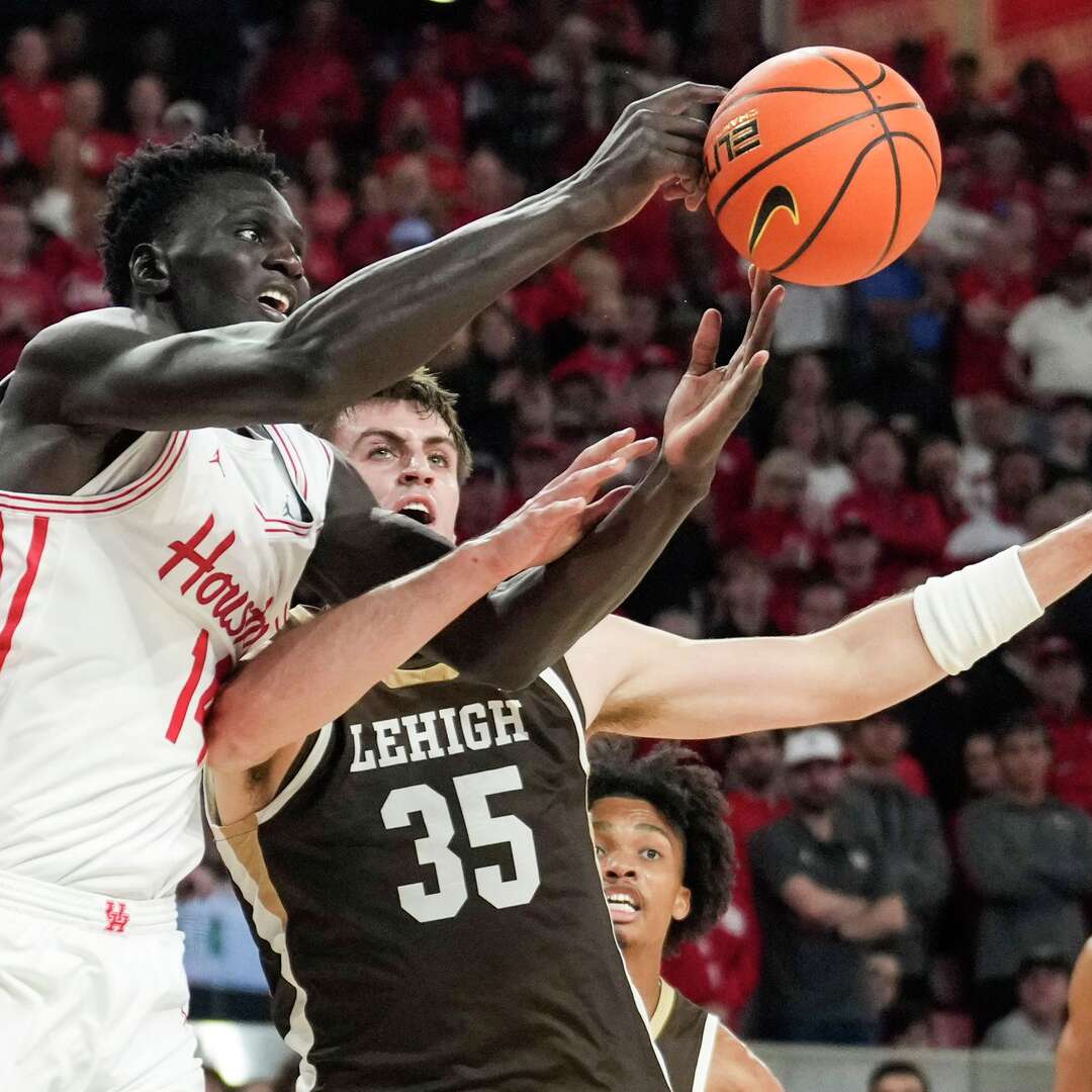 Houston forward Kalifa Sakho (14) and Lehigh forward Hank Alvey (35) fight for a rebound during the first half of an NCAA college basketball game at Fertitta Center in Houston, Monday, Nov. 3, 2025.