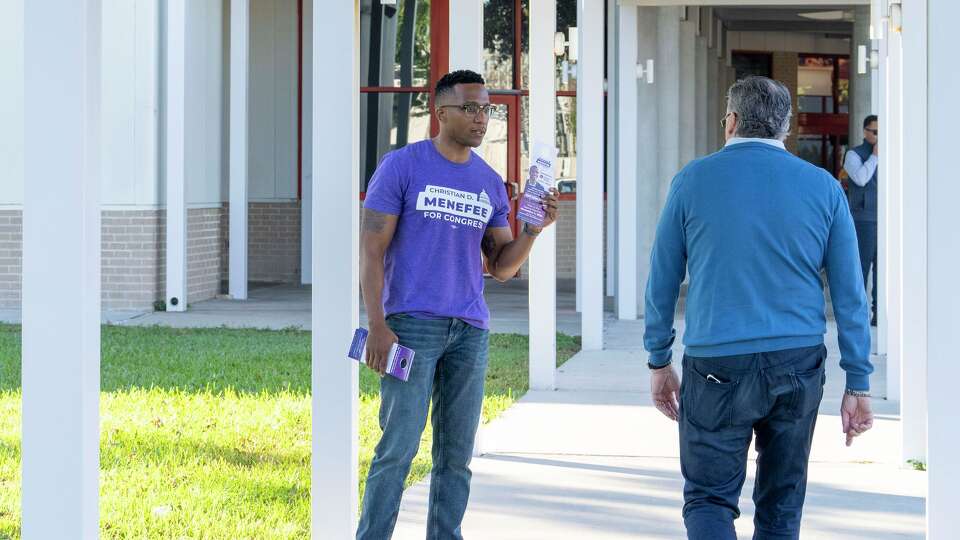 Harris County attorney and candidate for U.S. House of Representatives District 18, Christian Menefee, greets voters as they arrive at the Metropolitan MultiService Center polling location on West Gray Street in Houston, Tuesday, Nov., 4, 2025.