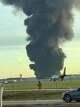 This photo provided by Brad Harvey shows thick, black smoke rising after reports of a plane crash near Louisville International Airport, Tuesday, Nov. 4, 2025, in Louisville, Ky. (Brad Harvey via AP)