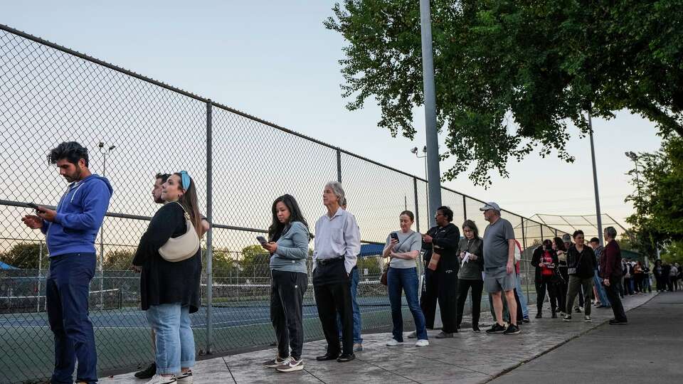 Voters wait in line outside the Metropolitan Multi-Service Center to cast their ballots in Houston, Tuesday, Nov. 4, 2025.