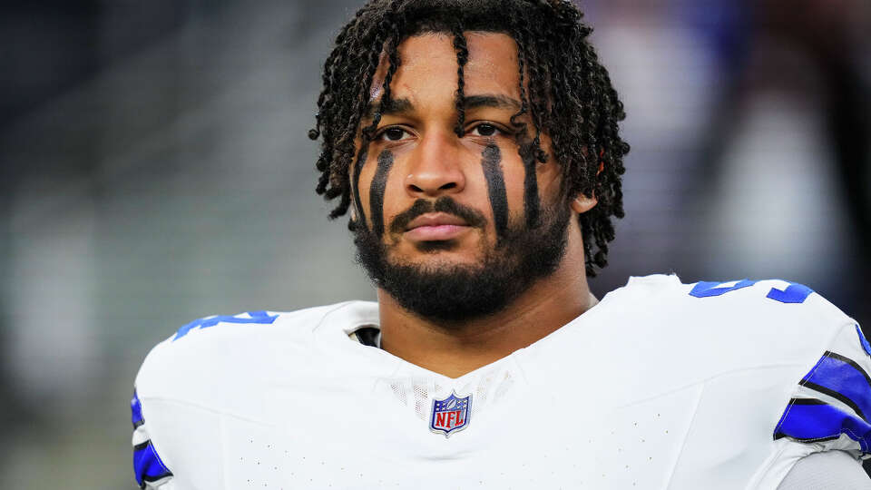 Marshawn Kneeland of the Dallas Cowboys looks on from the sideline during the national anthem prior to an NFL football game against the Tampa Bay Buccaneers at AT&T Stadium on December 22, 2024 in Arlington, Texas.
