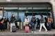 Travelers wait in the pick-up zones at San Francisco International Airport on Nov. 27, 2024. The federal government shutdown has already triggered widespread flight delays and cancellations as airports grapple with staffing shortages. Now, with the Federal Aviation Administration preparing to cut 10% of air traffic at the nation’s busiest airports, including SFO.