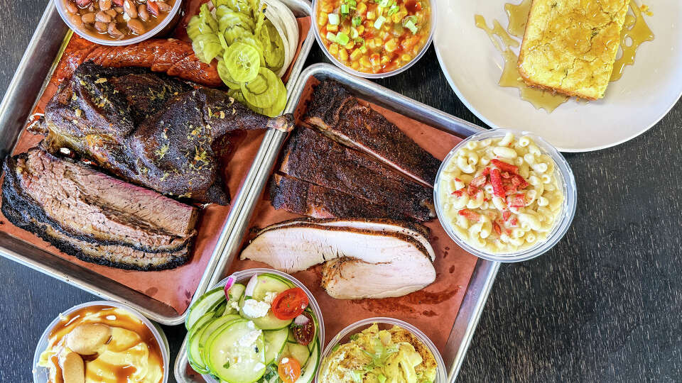 A spread from Victorian's Barbecue: brisket, jerk-seasoned chicken, charro beans, maque choux, honey cornbread, pork ribs, turkey, mac-n-cheese, potato salad, cucumber salad and banana pudding.