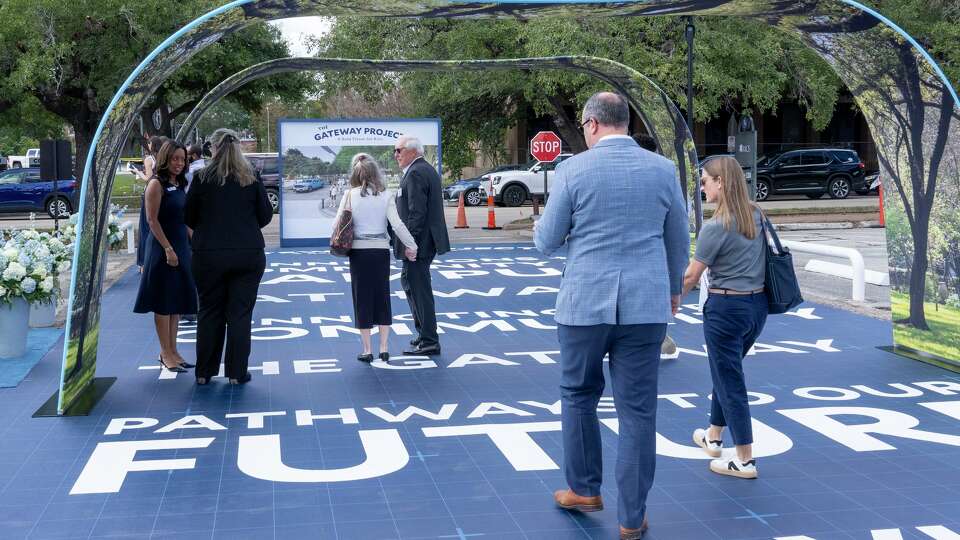 Pedestrians walk along a simulated roadway built to convey how the proposed right of way might connect the Rice University Campus to the retail, residential and business community of Rice Village as part of the Gateway Project during a ceremony at the campus in Houston, Thursday, Nov., 6, 2025.