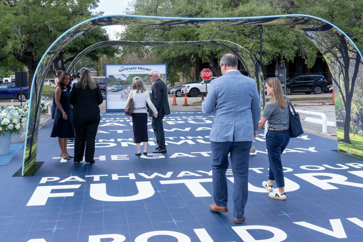 Pedestrians walk along a simulated roadway built to convey how the proposed right of way might connect the Rice University Campus to the retail, residential and business community of Rice Village as part of the Gateway Project during a ceremony at the campus in Houston, Thursday, Nov., 6, 2025.