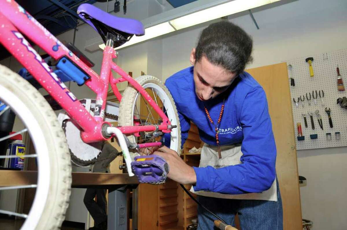 Jovan Baez, 18, works on a bike at the Trafigura Work & Learn Business Center at DOMUS on Lockwood Avenue in Stamford on Wednesday, Nov. 3, 2010.