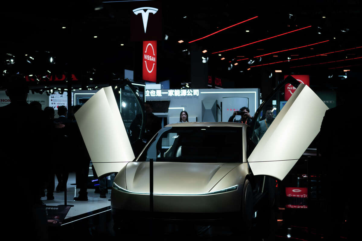Tesla Cybercab self-driving car is on display during the 8th China International Import Expo (CIIE) at the National Exhibition and Convention Center (Shanghai) on November 5, 2025 in Shanghai, China.  