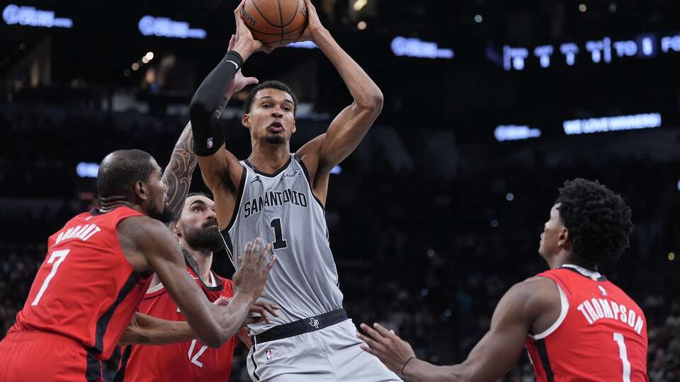 San Antonio Spurs forward Victor Wembanyama, center, is pressured by Houston Rockets forward Kevin Durant (7), center Steven Adams (12) and guard Amen Thompson, right, during the first half of an NBA Cup basketball game in San Antonio, Friday, Nov. 7, 2025. (AP Photo/Eric Gay)