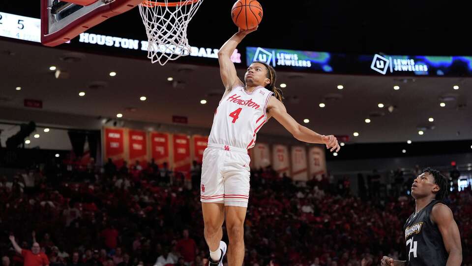 Houston Cougars guard Kingston Flemings dunks during the first half of an NCAA college basketball game against the Towson Tigers in Houston, Saturday, Nov. 8, 2025. (AP Photo/Ashley Landis)