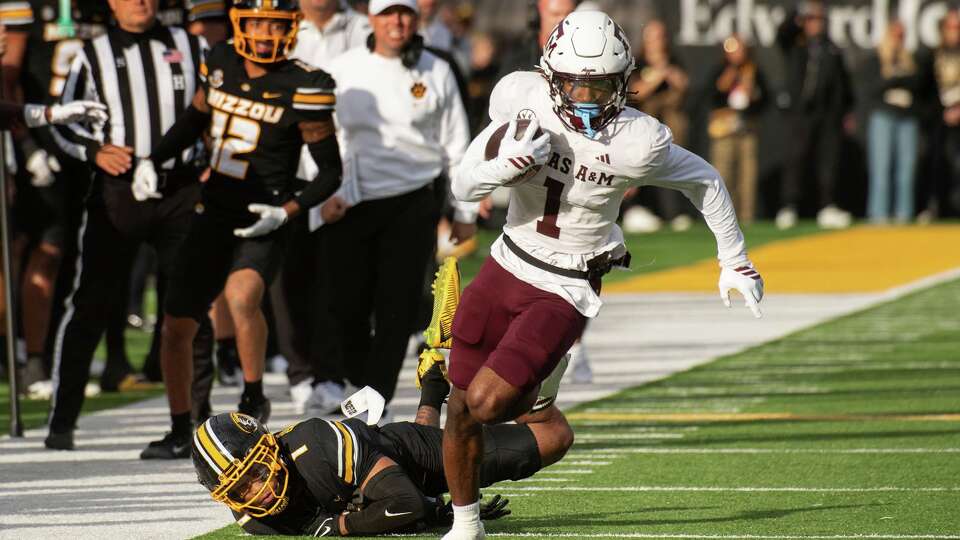 Texas A&M wide receiver Mario Craver, right, runs past Missouri safety Marvin Burks, left, during the first half an NCAA college football game Saturday, Nov. 8, 2025, in Columbia, Mo.