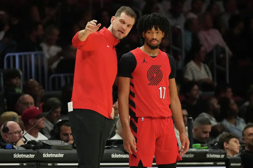 Portland Trail Blazers acting head coach Tiago Splitter, left talks with guard Shaedon Sharpe (17) during the first half of an NBA basketball game against the Miami Heat, Saturday, Nov. 8, 2025, in Miami.