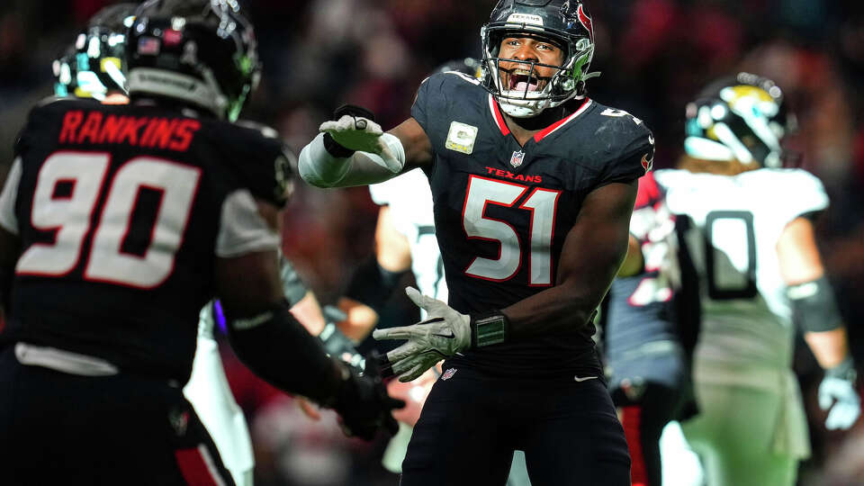 Houston Texans defensive end Will Anderson Jr. (51) reacts to a sack with defensive tackle Sheldon Rankins (90) in the fourth quarter against the Jacksonville Jaguars at NRG Stadium in Houston on Sunday, Nov. 9, 2025. Houston Texans won the game 36-29.
