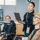 Woman teaching a class of workers with disabilities to use computers.