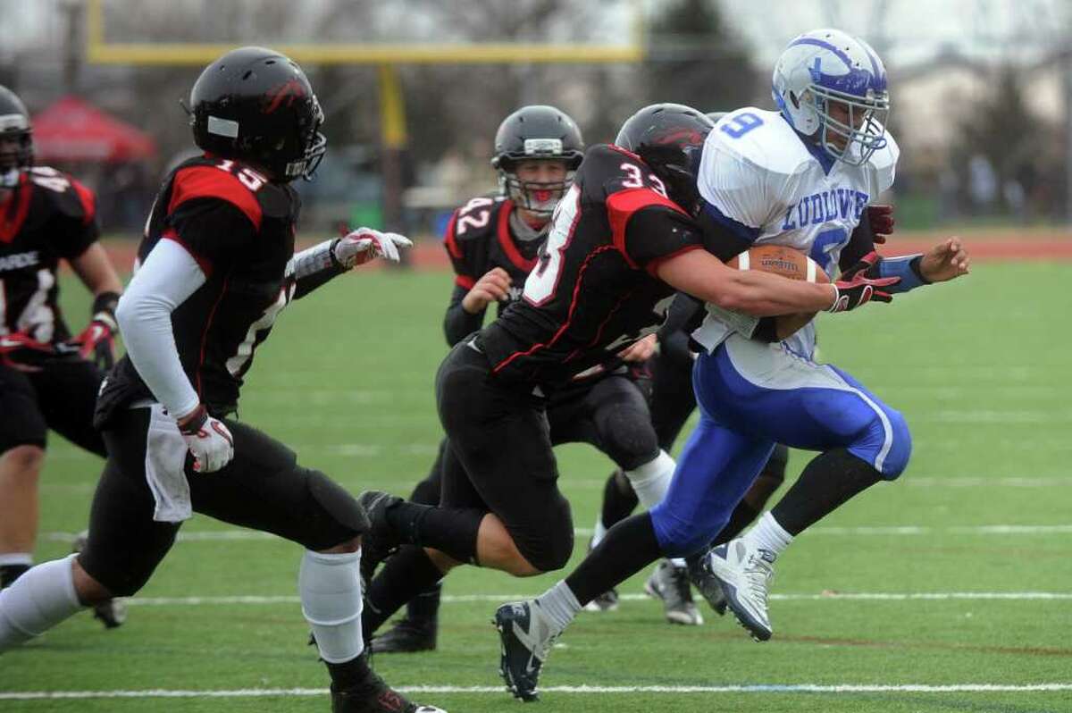 Fairfield Ludlowe's Thomas Hammons carries the ball during Thursday's Thanksgiving Day game at Fairfield Warde High School on November 25, 2010.