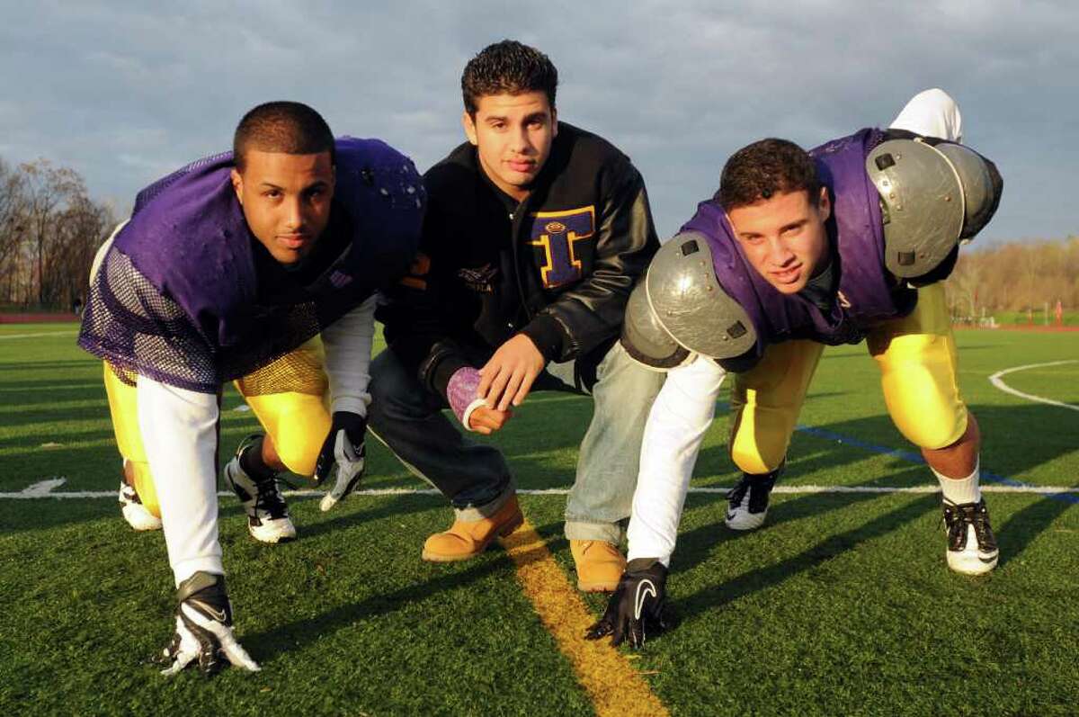 High school fall sports -- football -- Troy High School defensive ends Luis Lind, left, Victor Pirela, center, and Nick Valenti are all first-year starters, with Pirela and Valenti both 15-year-old sophomores. All have an uncanny ability to pressure opposing quarterbacks. (Cindy Schultz / Times Union)