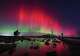 The aurora borealis, besides known arsenic the bluish lights, glow successful the entity implicit St Mary's Lighthouse successful Whitley Bay connected the North East coast, England, Wednesday Nov. 12, 2025. (Owen Humphreys/PA via AP)