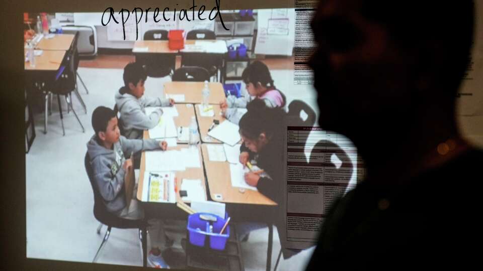 Juan Garcia works with his third graders one a reading lesson at HISD’s A.A. Milne Elementary School in Houston, Wednesday, Nov. 12, 2025. HISD's Milne Elementary School is second most improved elementary schools in the Houston area according to Children At Risk's annual rankings.
