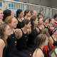 The Greenwich girls pose for a photo with the championship plaque and banner after winning the Class LL state swimming title on Wednesday, Nov. 12, 2025, in West Hartford.