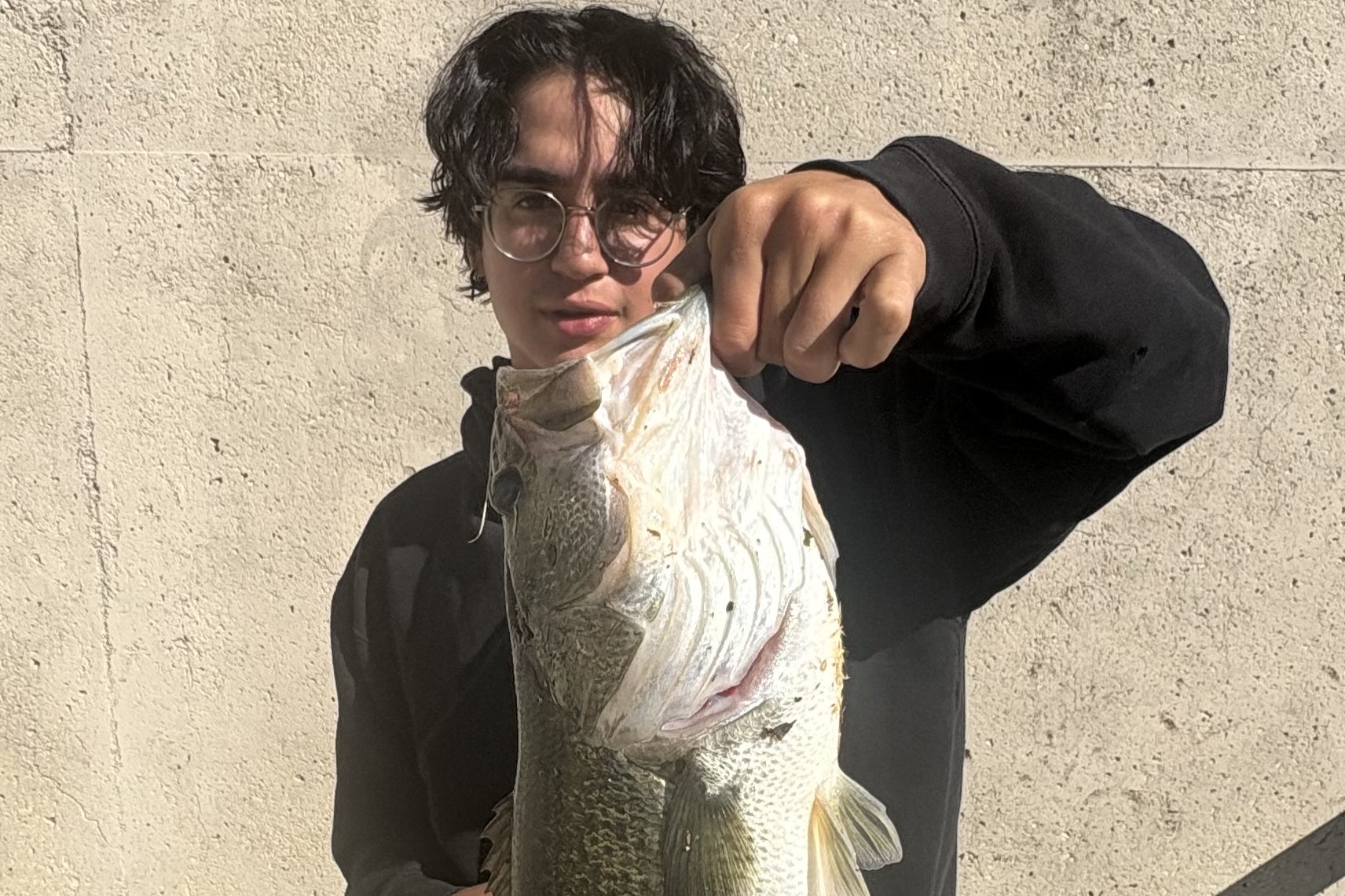 Angler Fish Spoting San Antonio River Walk angler reels in an 8-pound bass